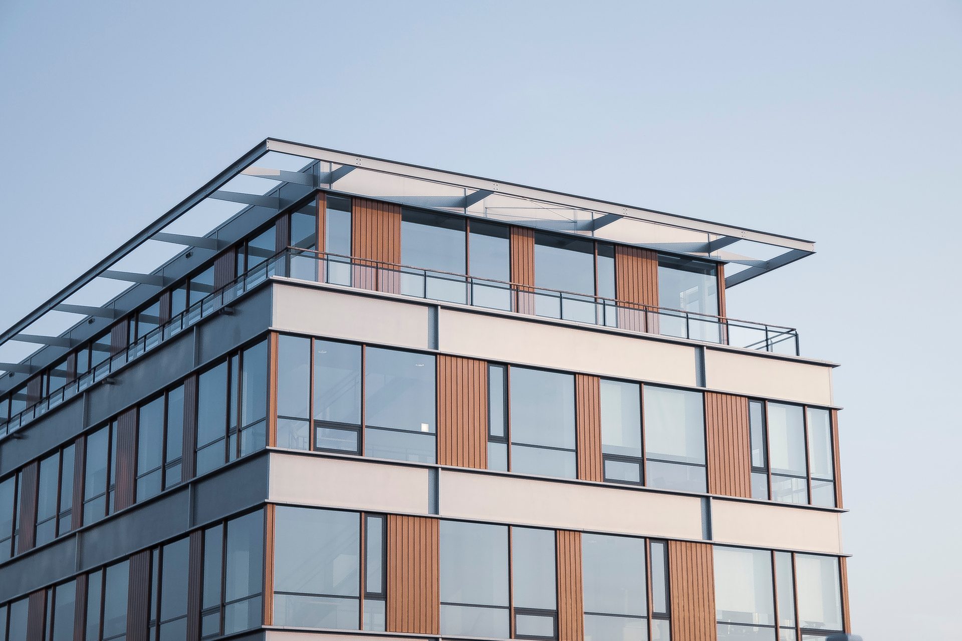 Modern multi-story building with large windows and wood accents.