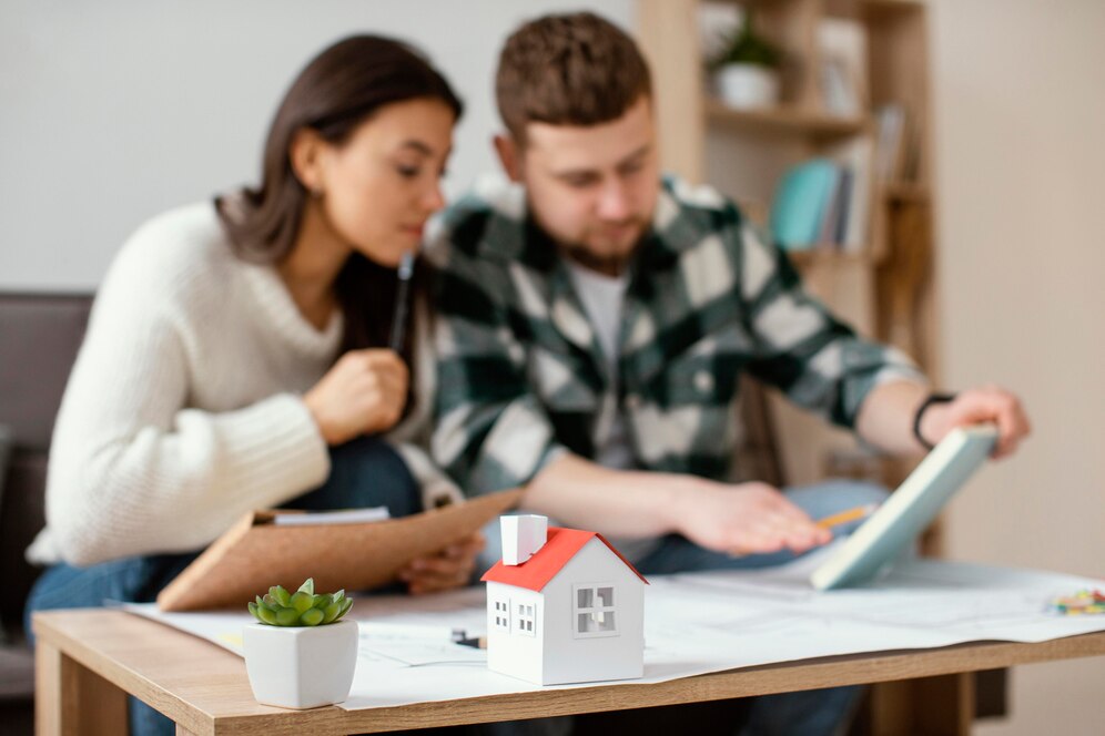 Couple reviewing NSW strata reform documents, planning home renovation.