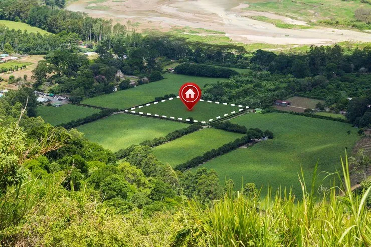 Aerial view of farmland with a plot of land marked for sale or development. International estate planning.