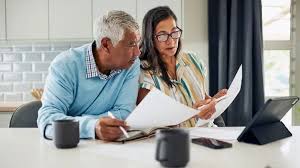 Senior couple reviewing financial documents, planning for the future.