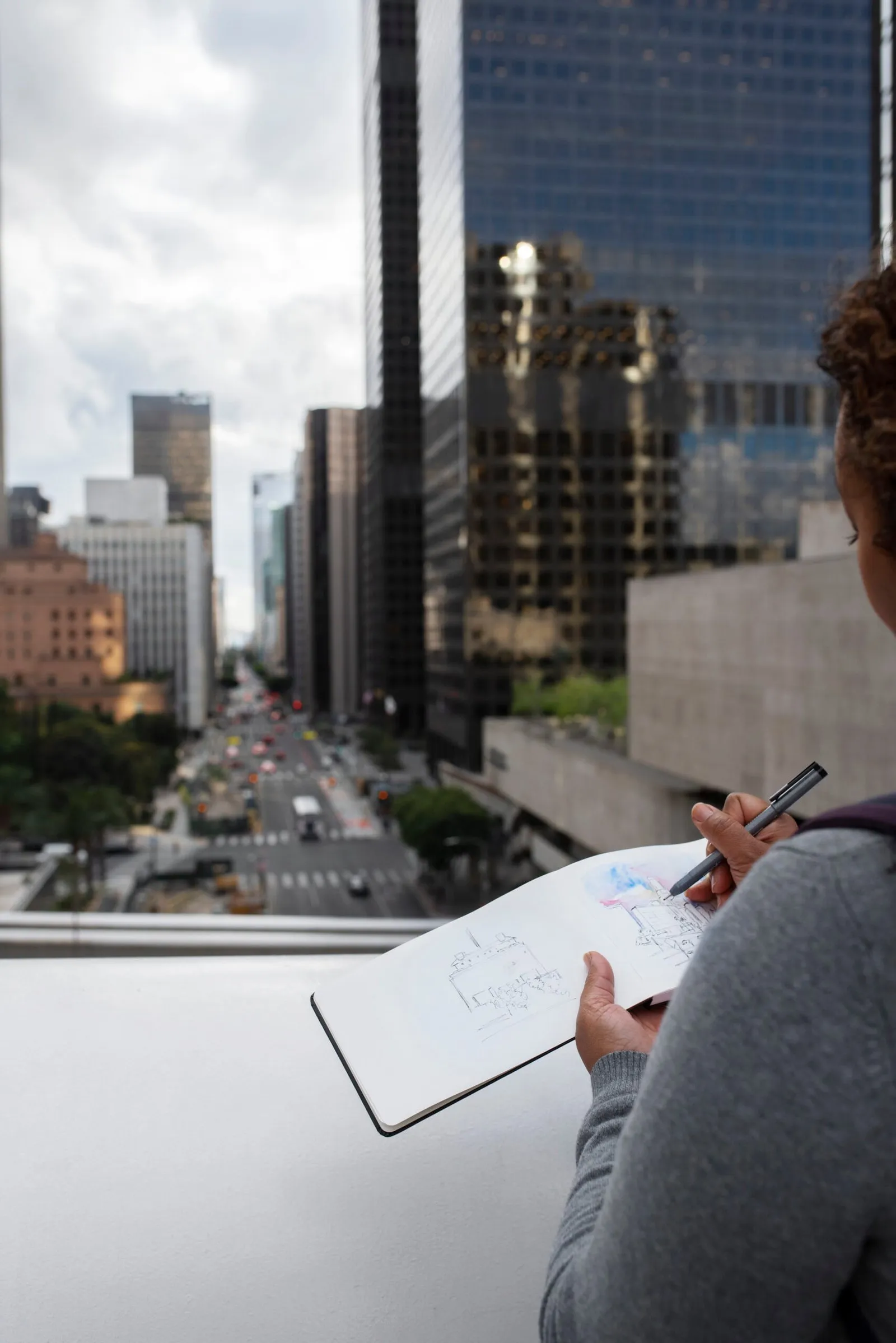 Person sketching cityscape, possibly related to NSW strata law case.