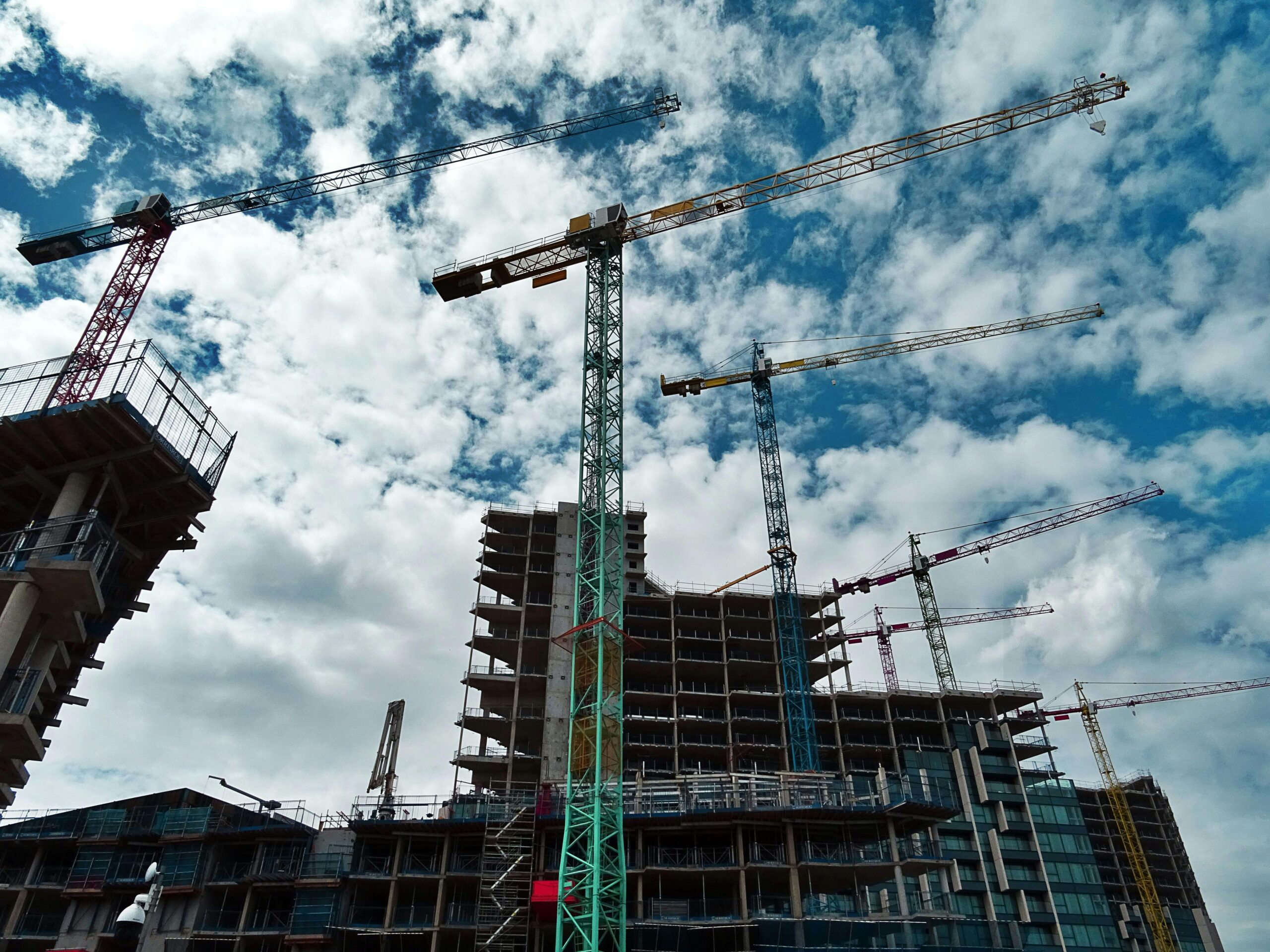 Construction site with multiple cranes and high-rise building under construction. NSW building regulations.