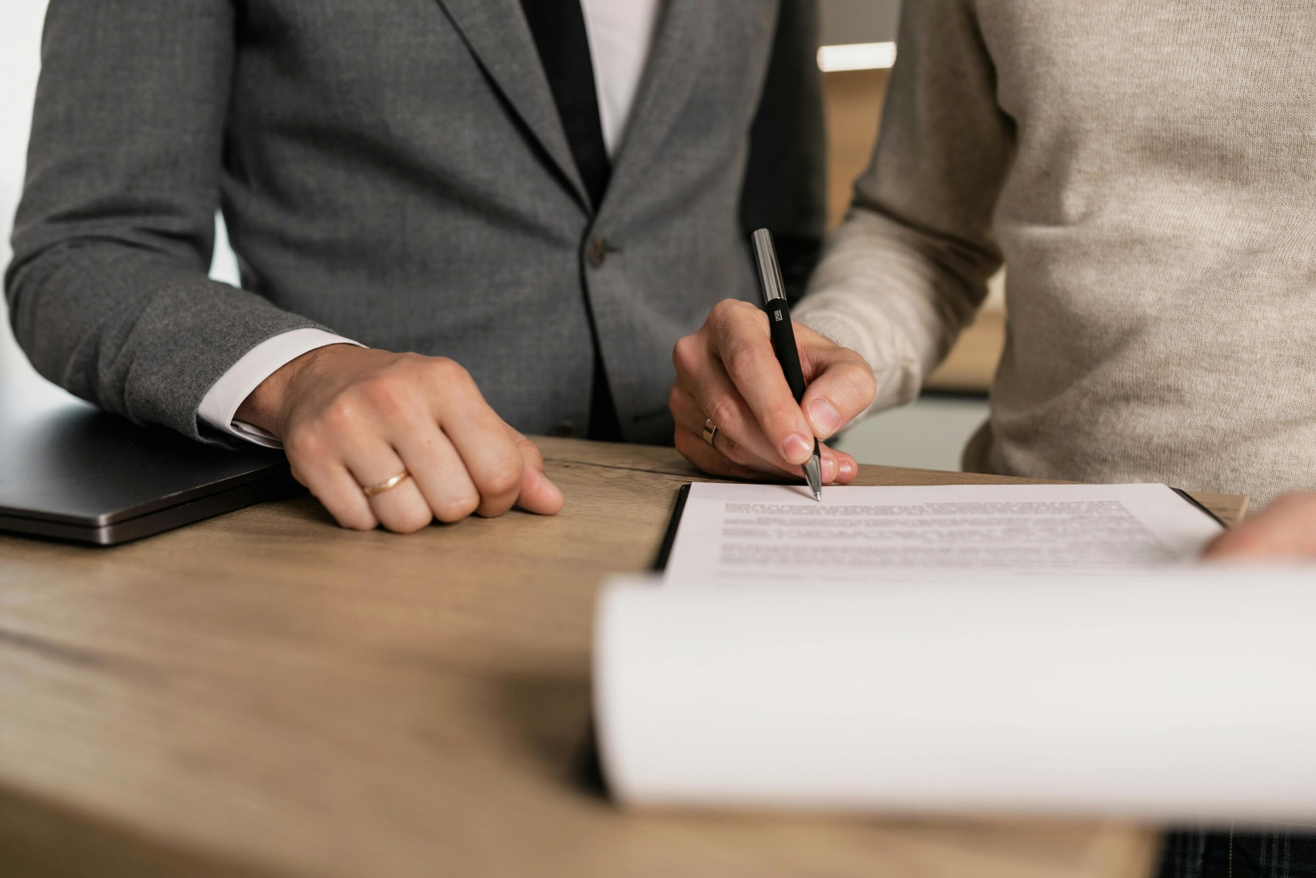 Person signing a legal document with a pen, preventing will contest in NSW.