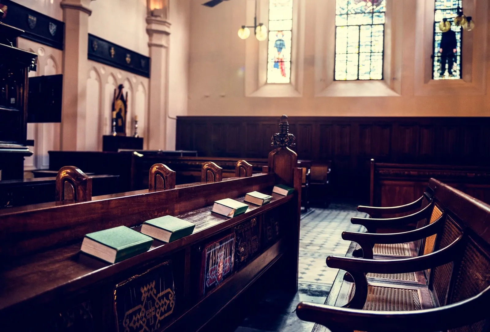 Empty courtroom benches in the NSW Supreme Court with stained glass windows