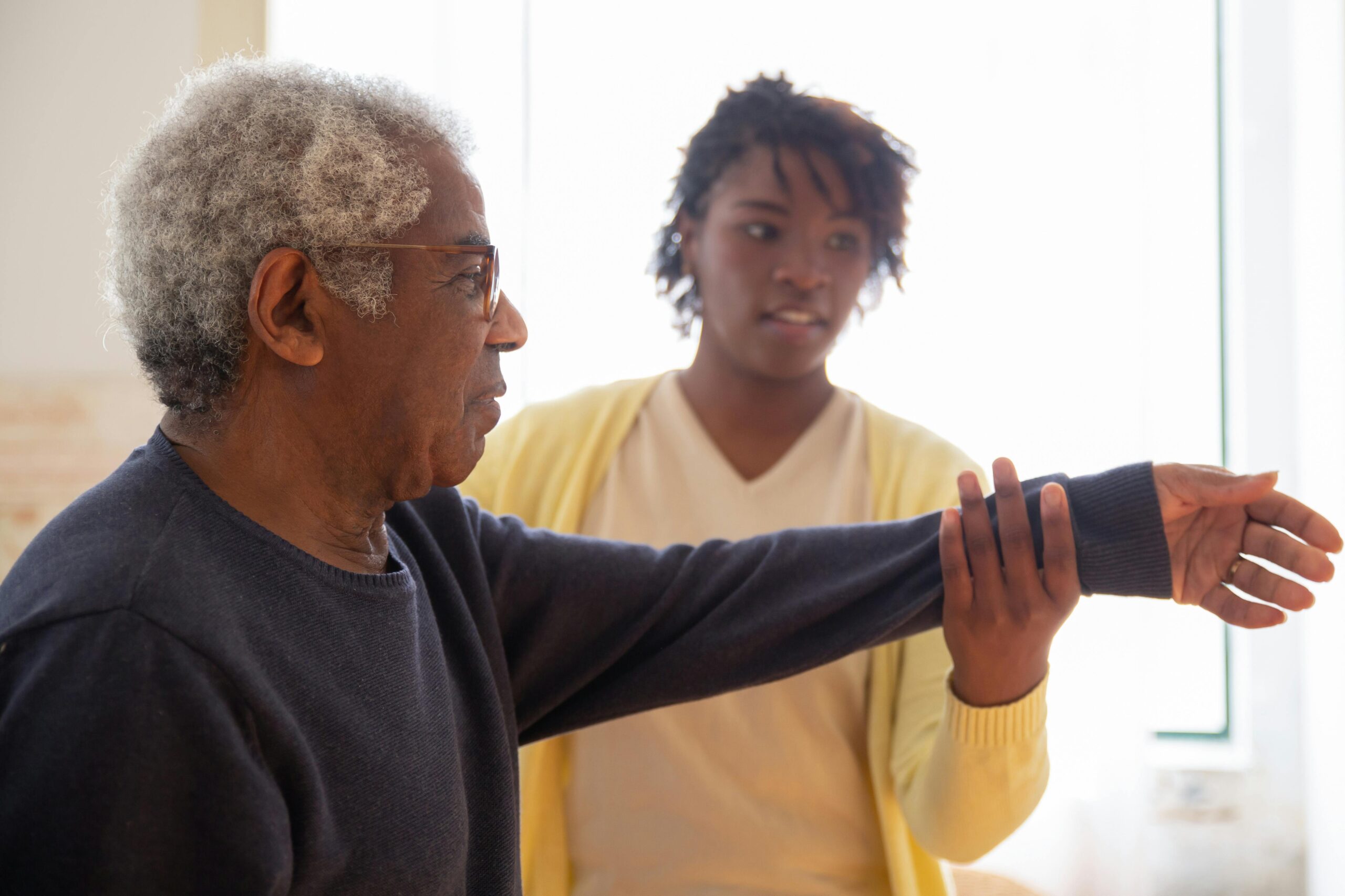 Elderly man receiving physical therapy, possibly related to De Facto Inheritance Law.