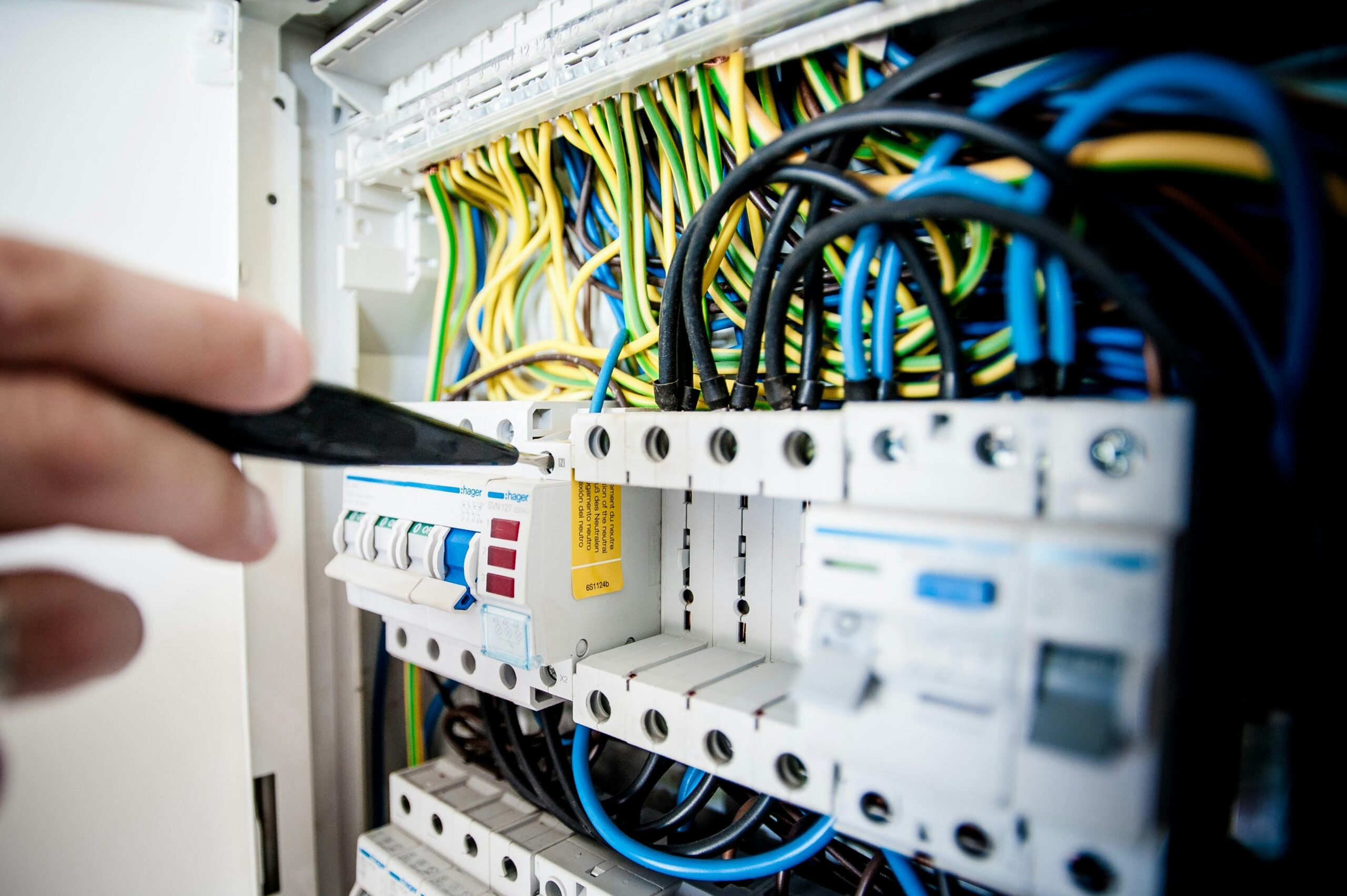 Electrical panel with wiring and circuit breakers, close-up.
