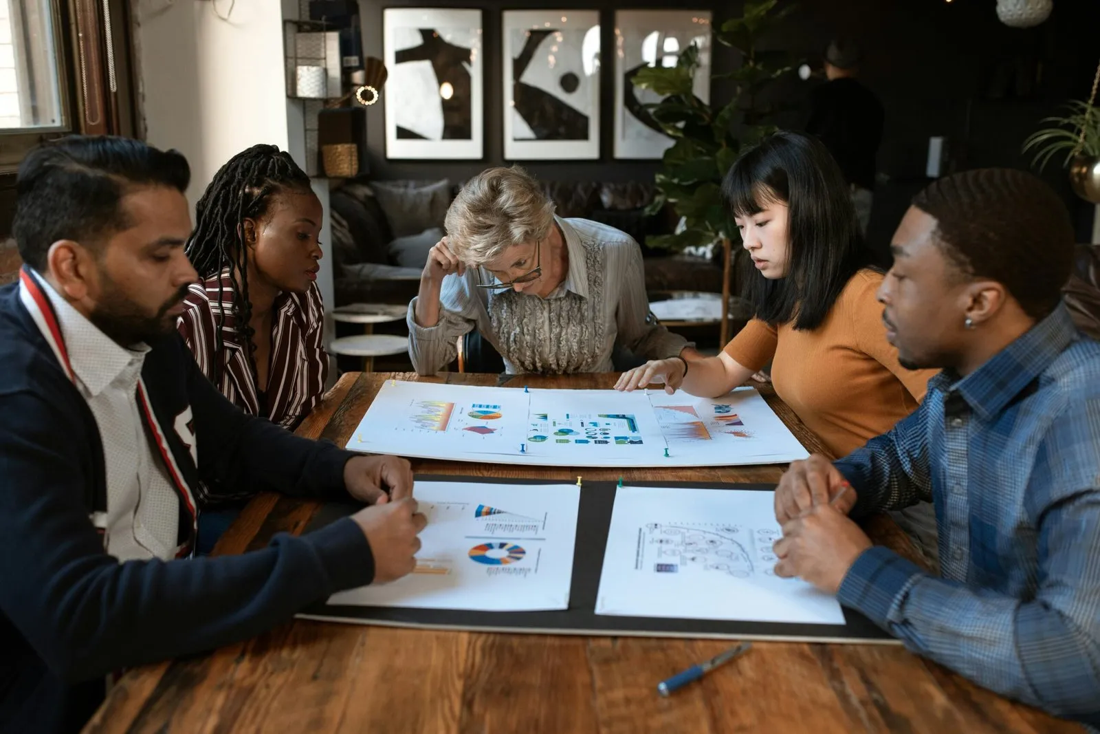Business team reviewing charts and graphs at a meeting table.