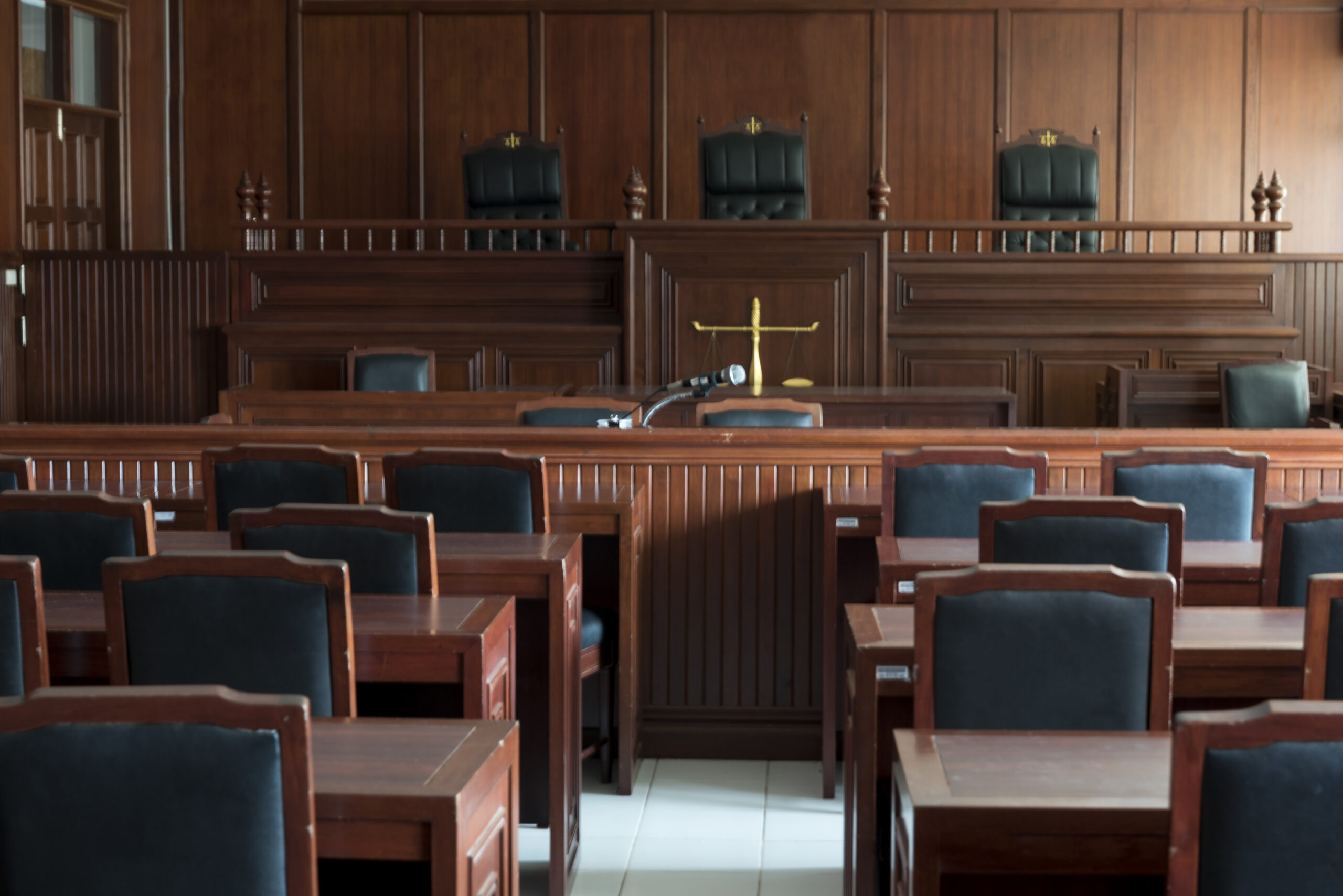 Empty courtroom with judge's bench and jury seating, relevant to content creators discussing taxes.