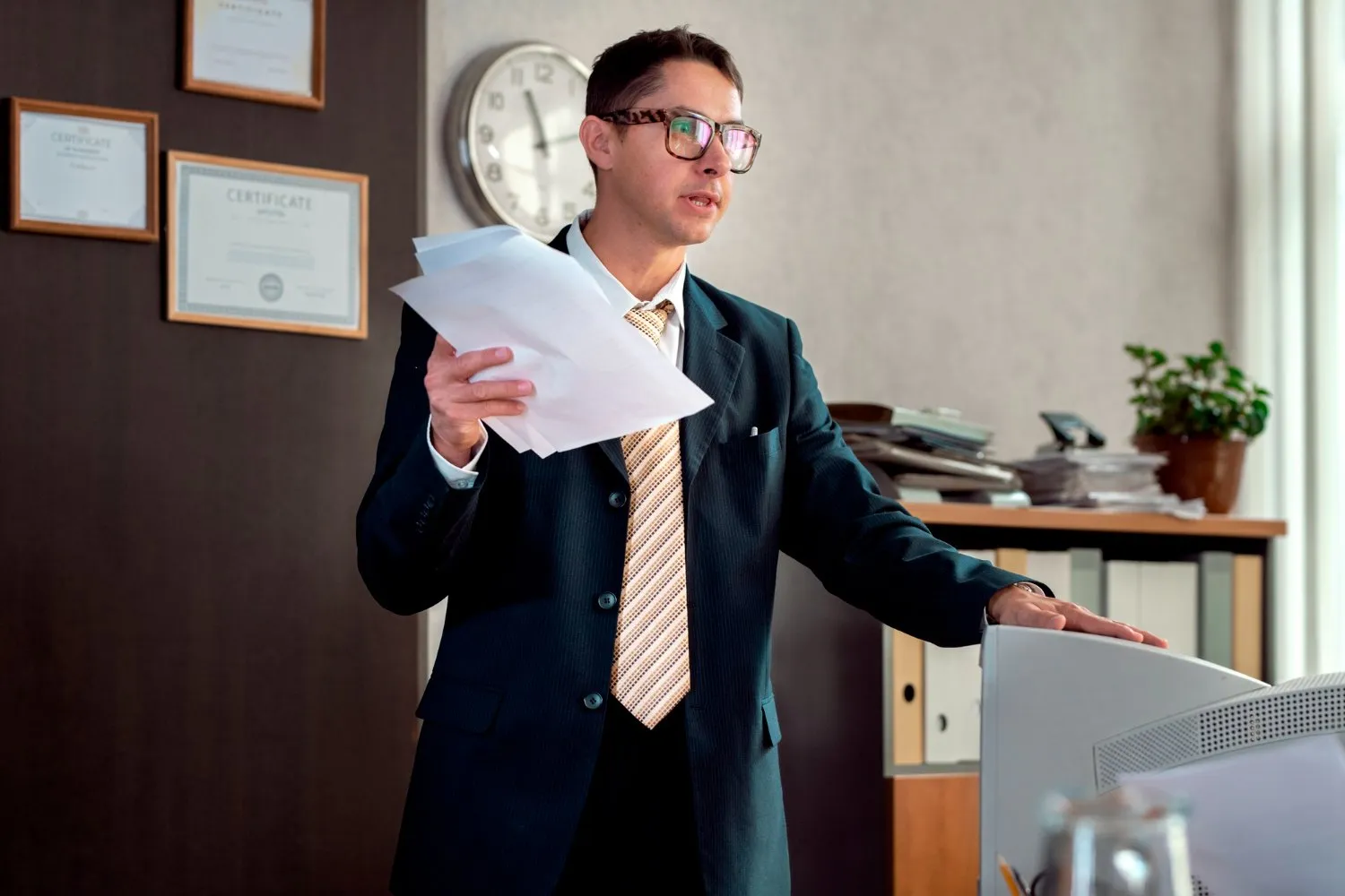 Man in suit holding probate documents in office, applying for probate in NSW.