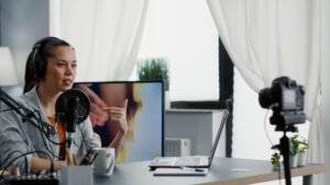 Female creator recording video for her YouTube channel about US taxes.