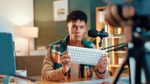 YouTuber holding a keyboard, filming content for his channel. Singapore content creator.